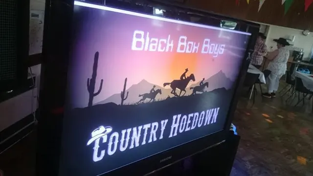 A screen showing a Black Box Boys Country Hoedown title with cowboys riding across a desert sunset