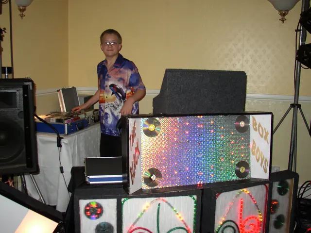 A young Darren behind a disco booth covered in sparkly lights at an early Black Box Boys disco